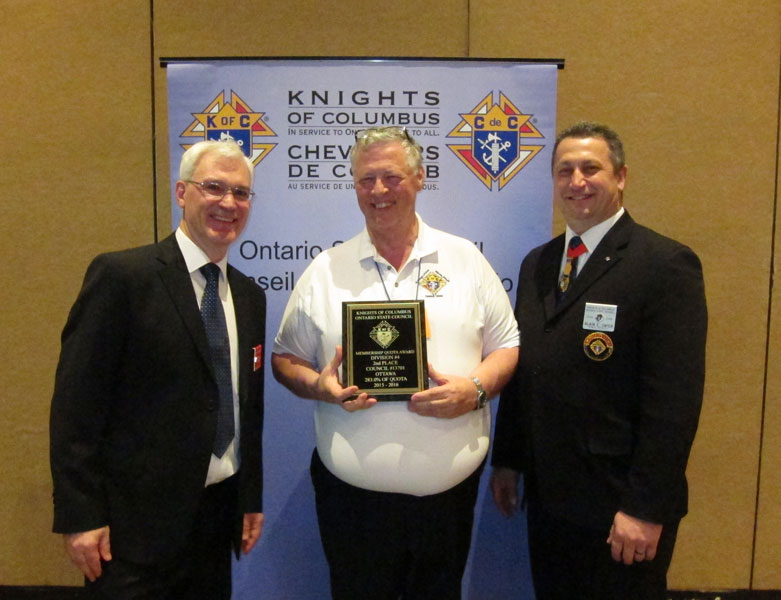 New member SK Douglas Randall, DD for district 92, accepts a State award on behalf of the council.